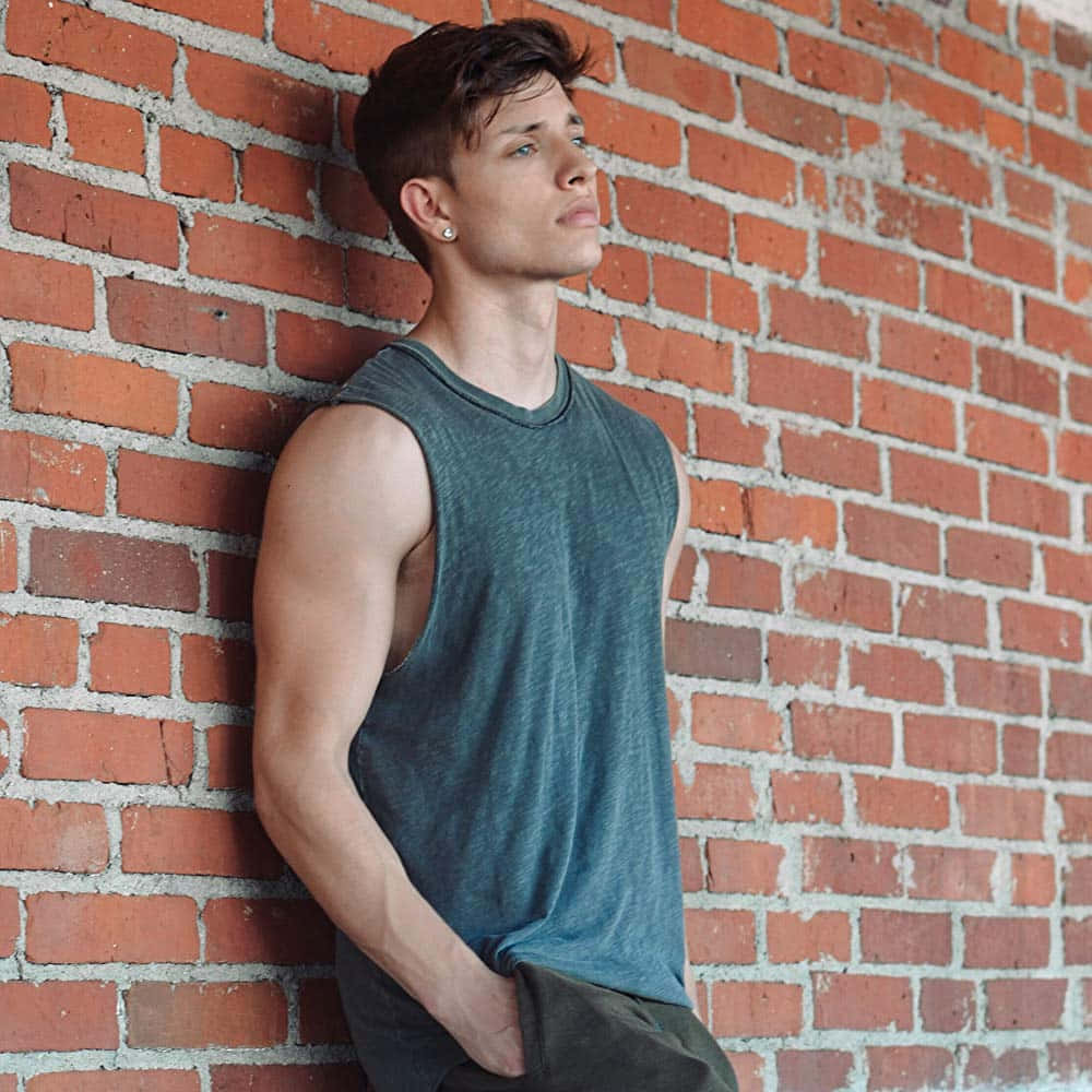 Matt Rife poses in a stylish outfit with a captivating smile Wallpaper
