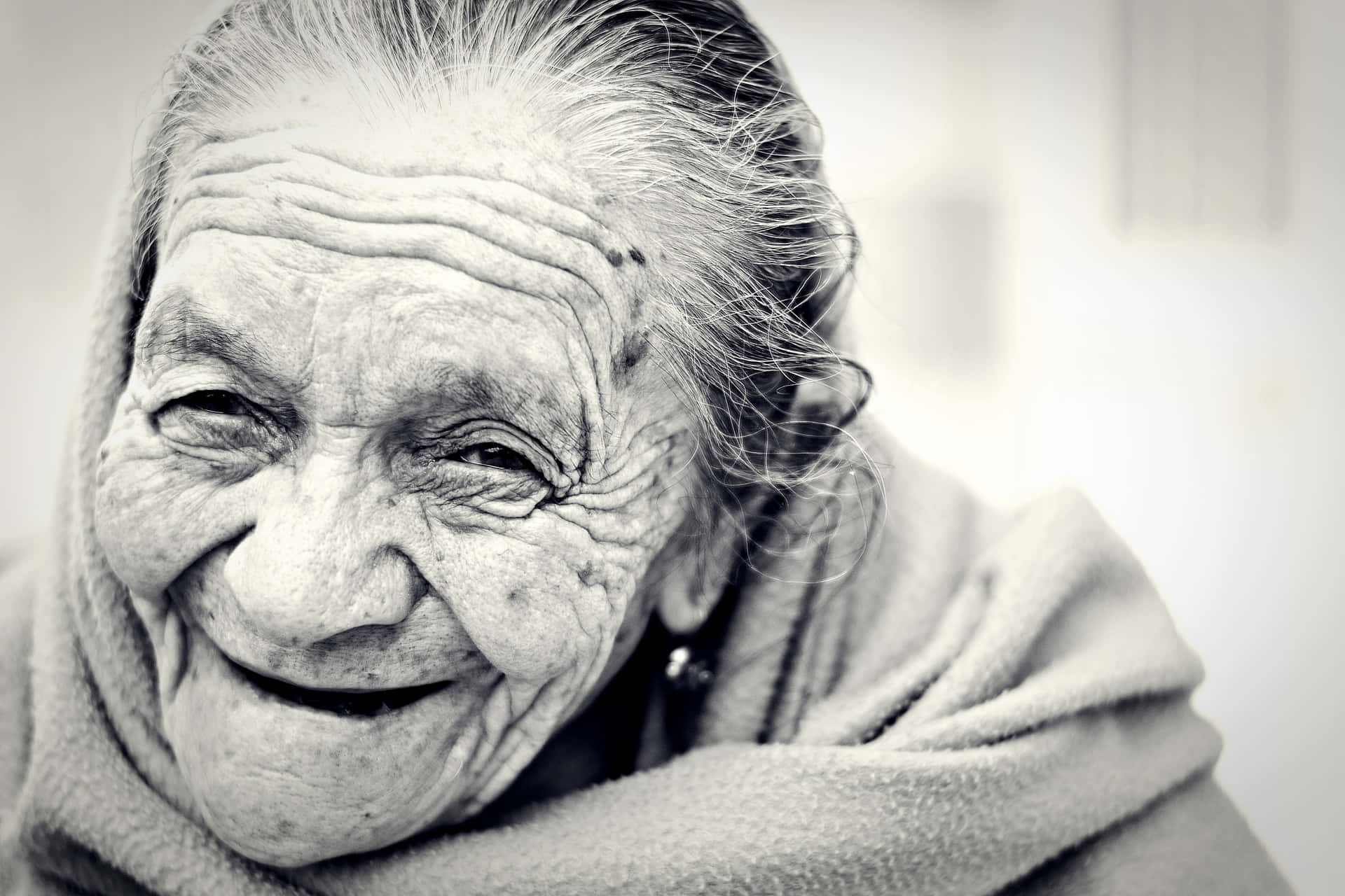 Mature Old Woman Smiling At The Camera Wallpaper