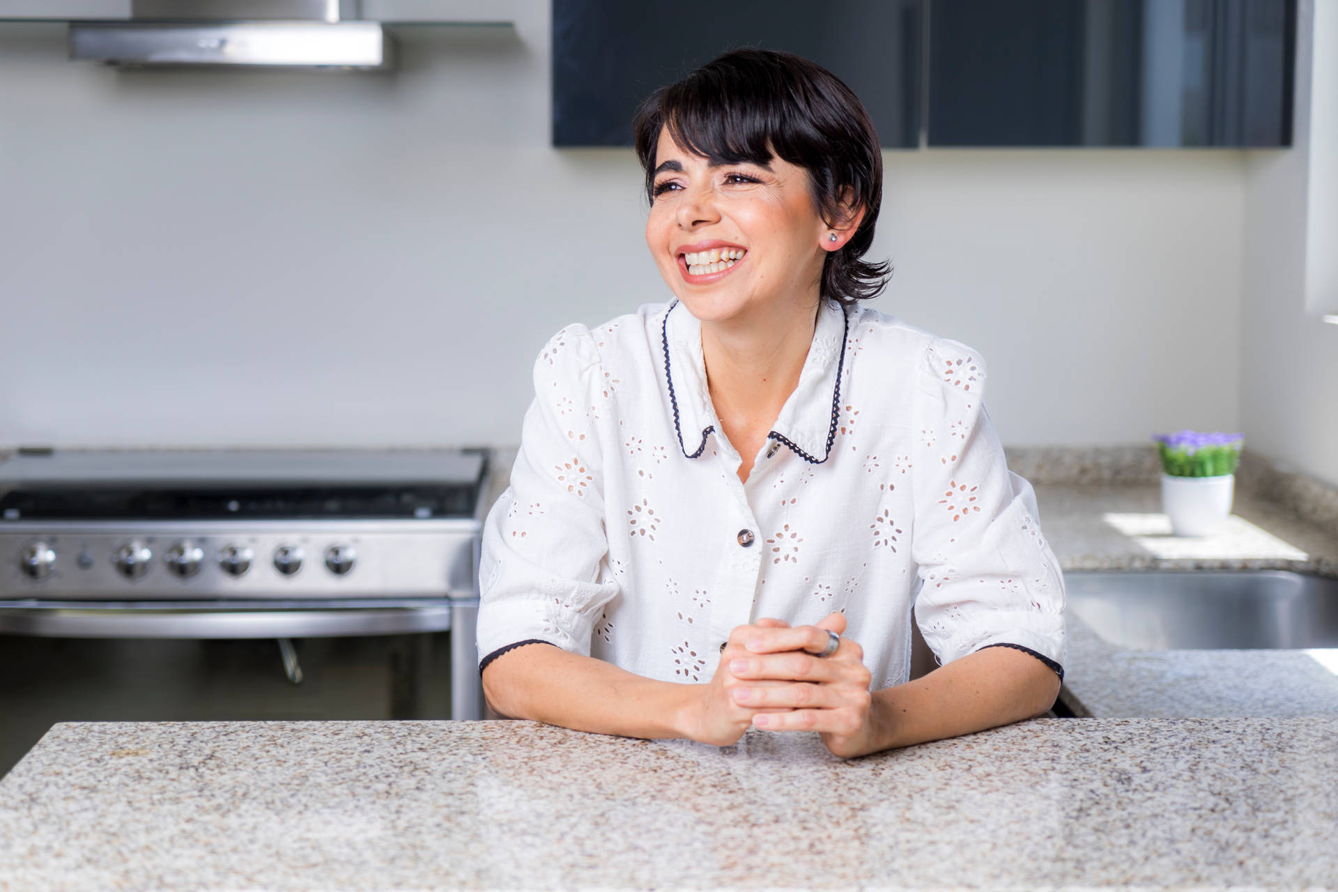 Mature Woman Posing In Her Clean Kitchen Wallpaper