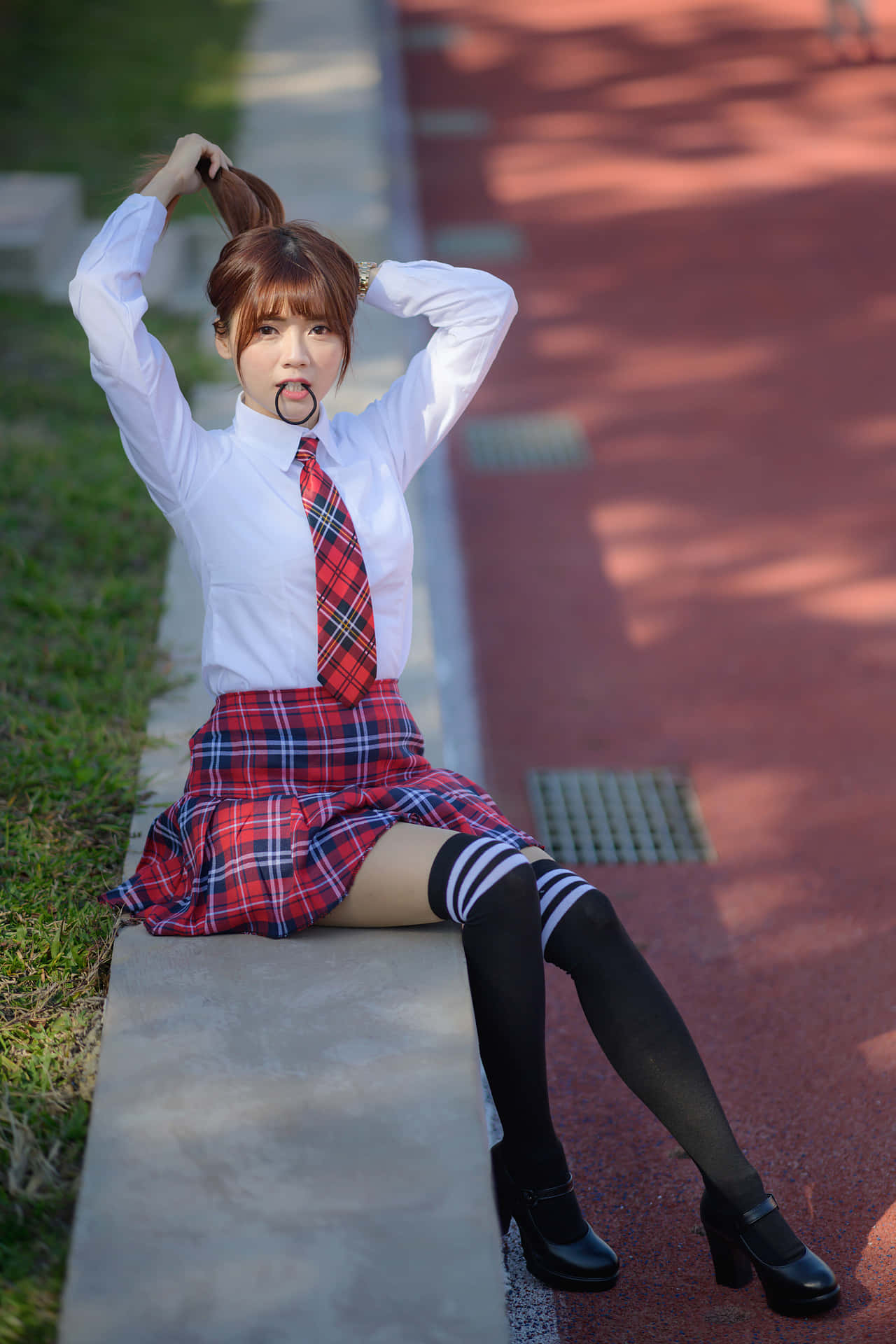 a girl in a red and white plaid skirt