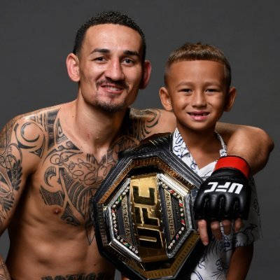 Max Holloway Holding Son And Belt Wallpaper
