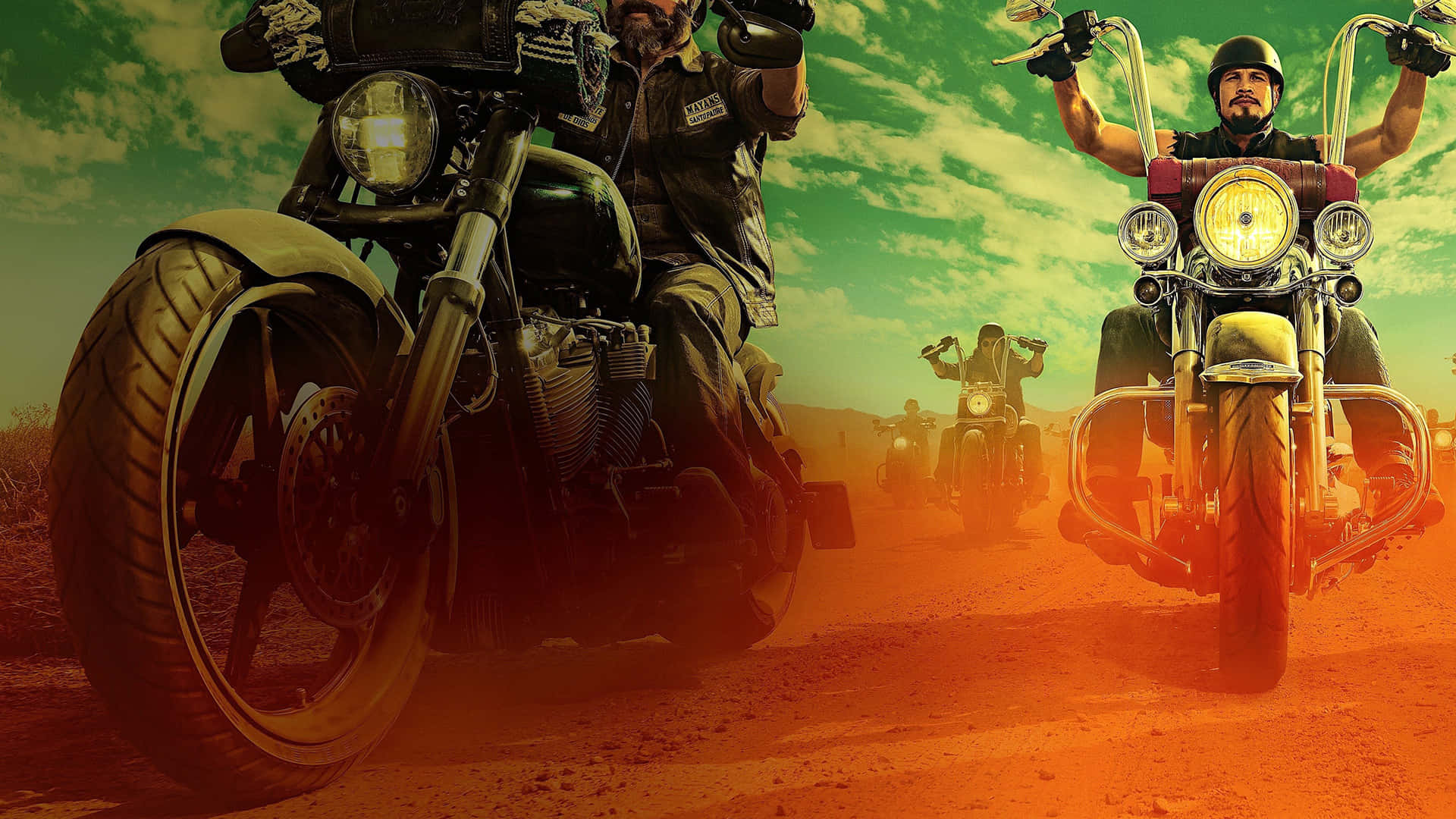 A Group Of Motorcycle Riders On A Dirt Road Wallpaper