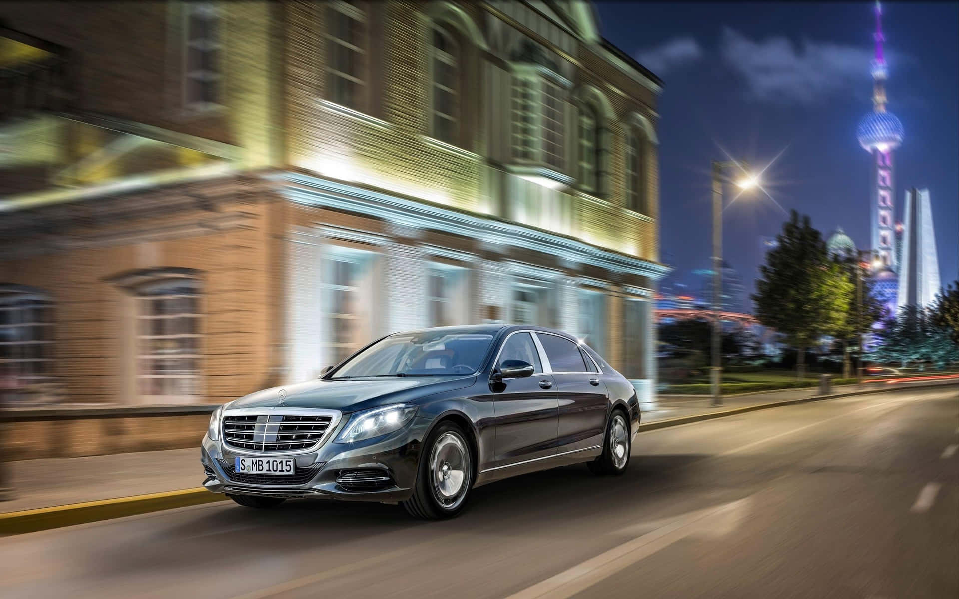 Sleek Maybach luxury vehicle parked under a striking sunset Wallpaper