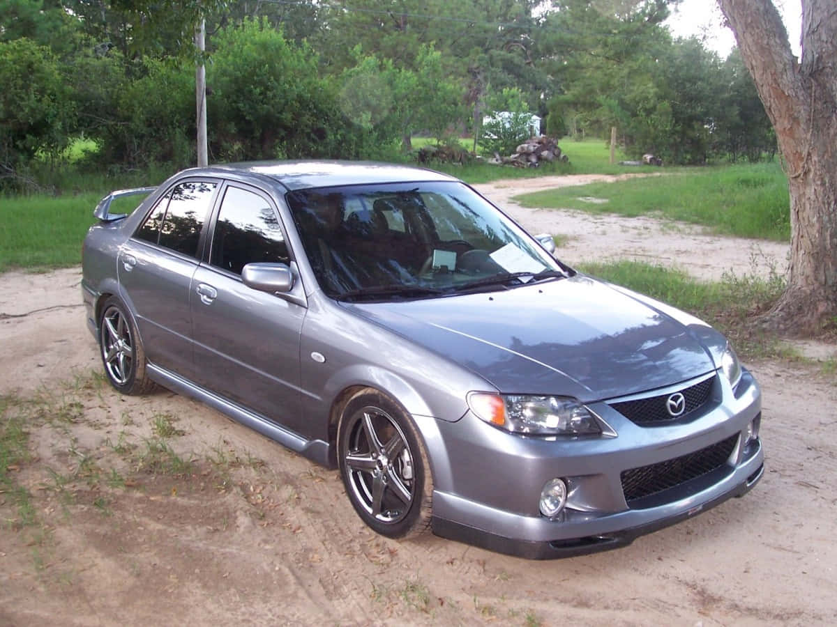 Sleek Mazda Protege in urban setting Wallpaper