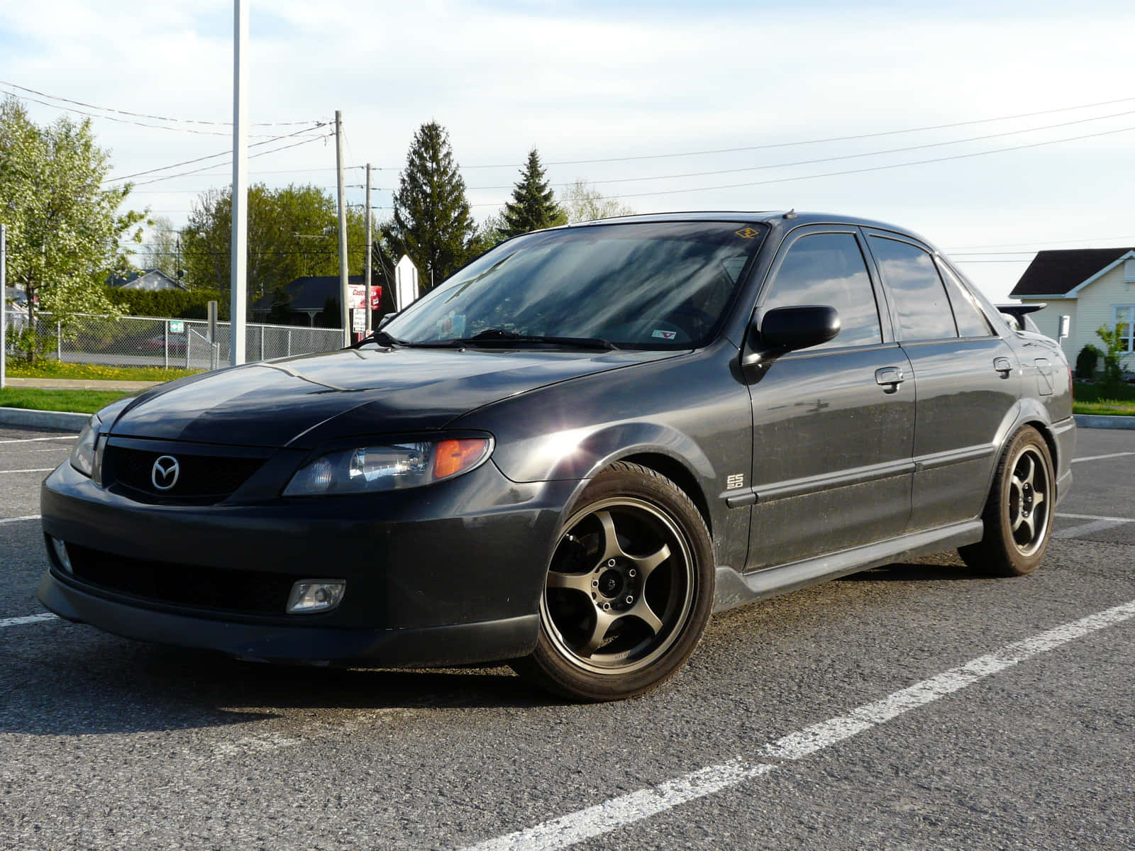 Sleek Mazda Protege cruising on the open road. Wallpaper