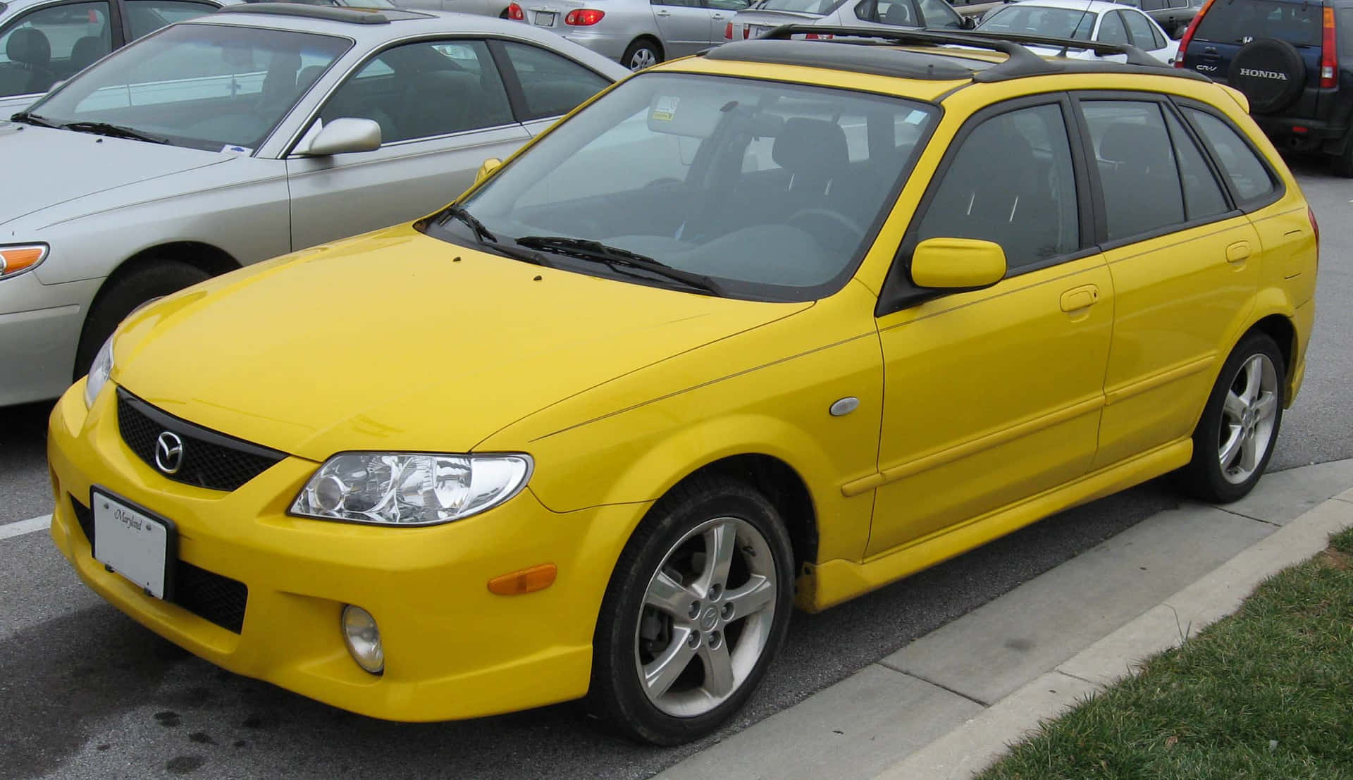 Mazda Protege on a Scenic Road Wallpaper