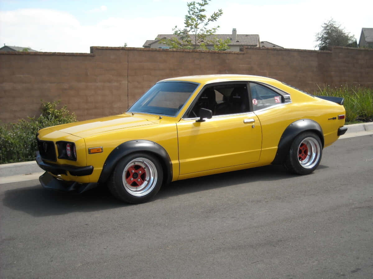 Stunning Mazda RX-3 in a picturesque landscape. Wallpaper