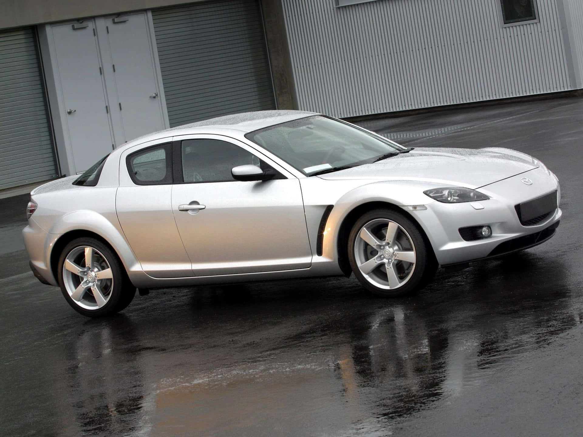 Sleek and Stylish Mazda RX-8 on the Road Wallpaper