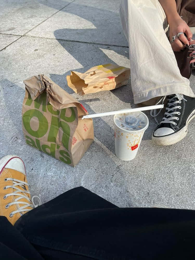 People Sitting With Mcdonalds Food On Ground Picture
