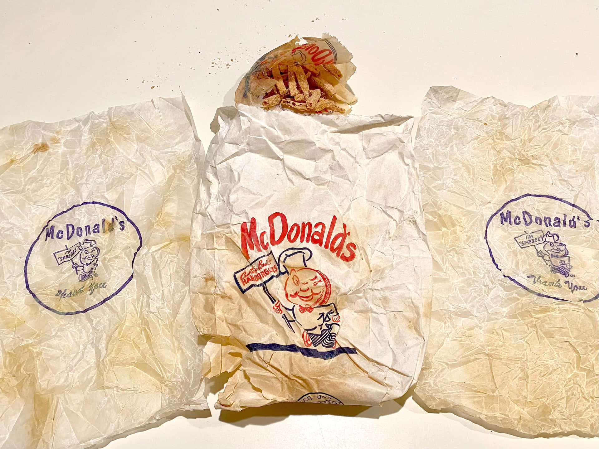 Three Bags Of Mcdonald's Food On A Table
