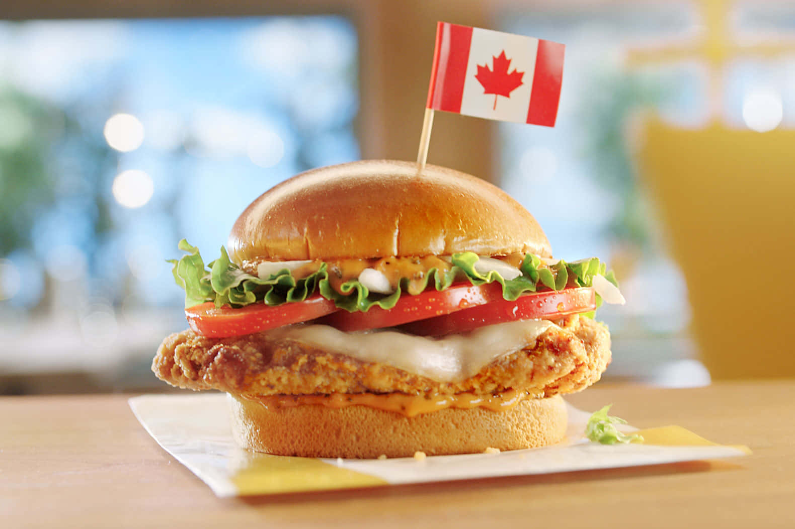 A Chicken Sandwich With A Canadian Flag On Top