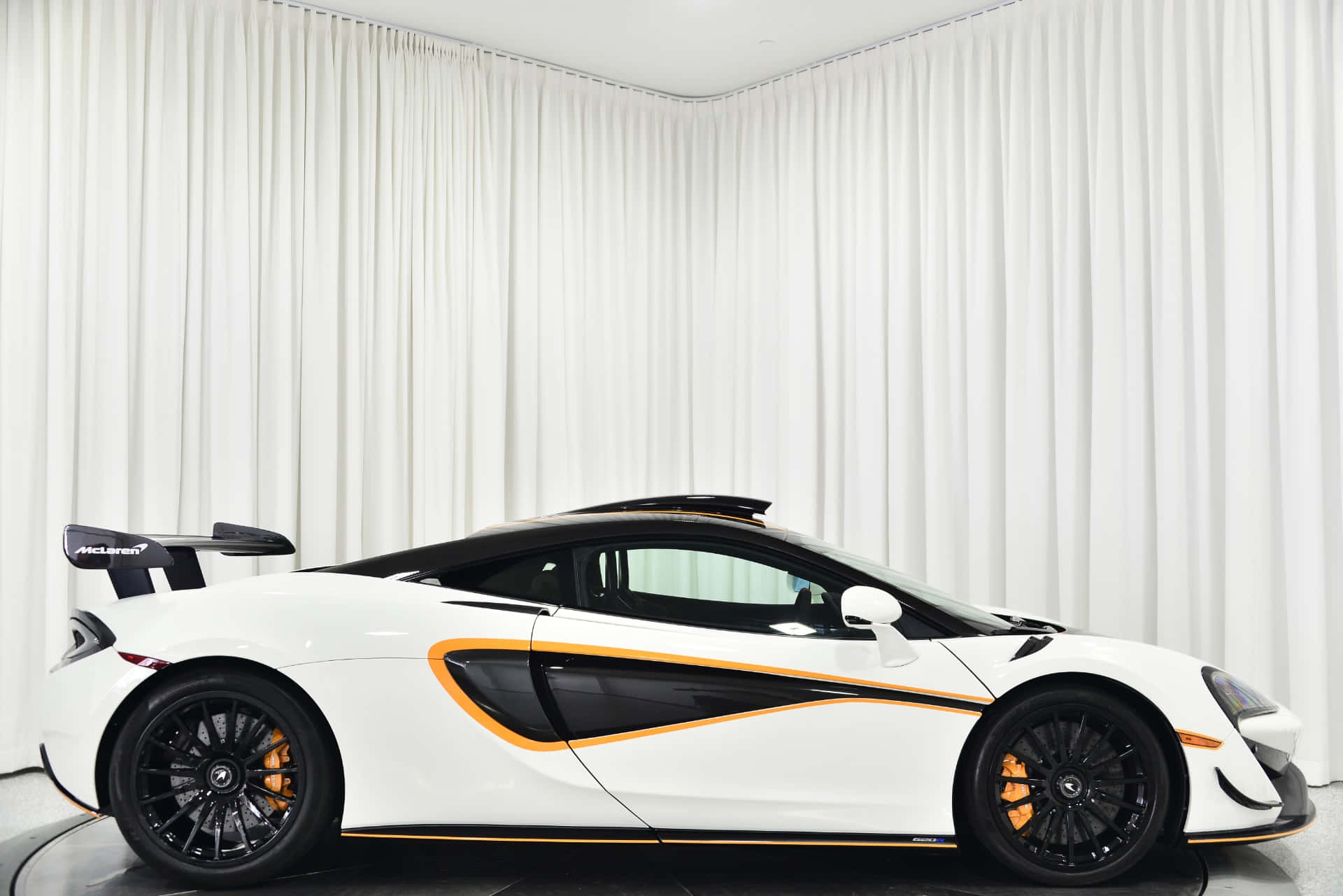 Sleek McLaren 620R Supercharged Sports Car Wallpaper