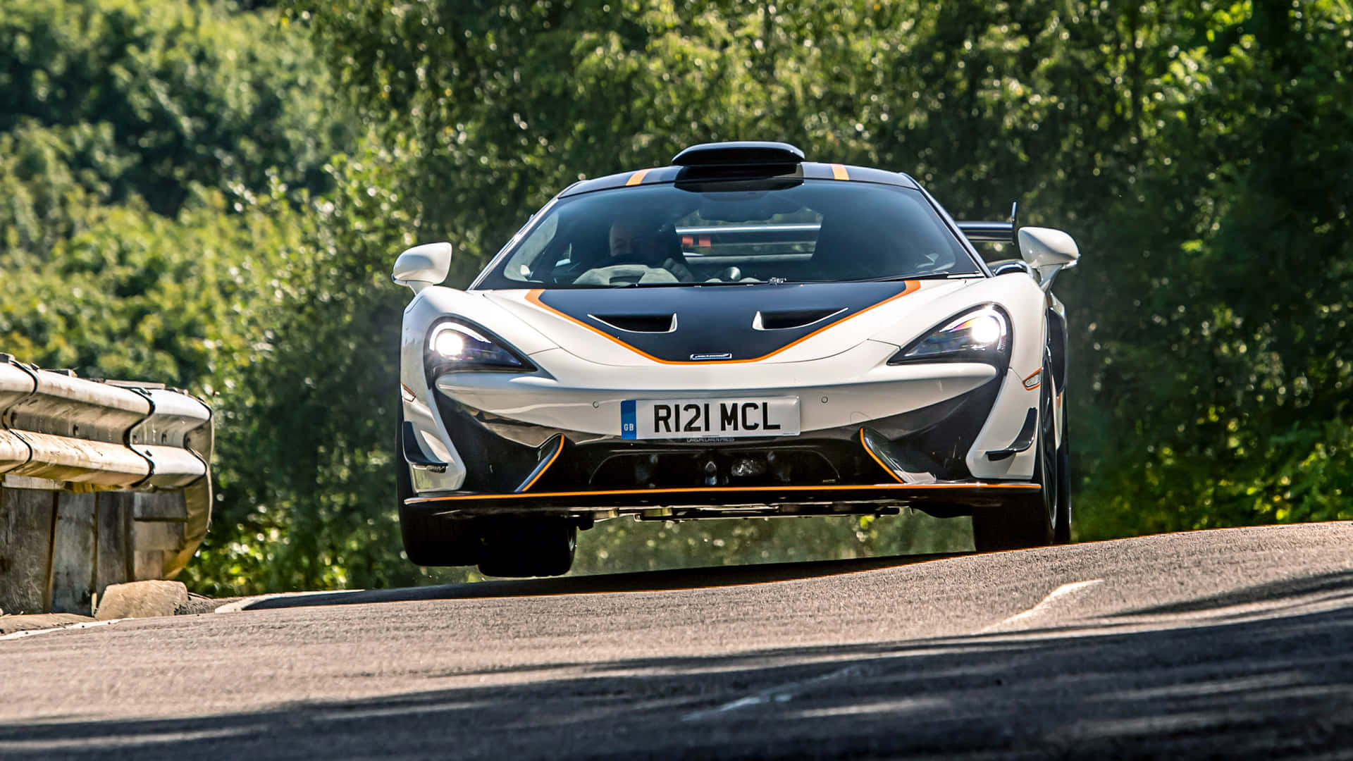 Sleek Silver McLaren 620R on the Road Wallpaper