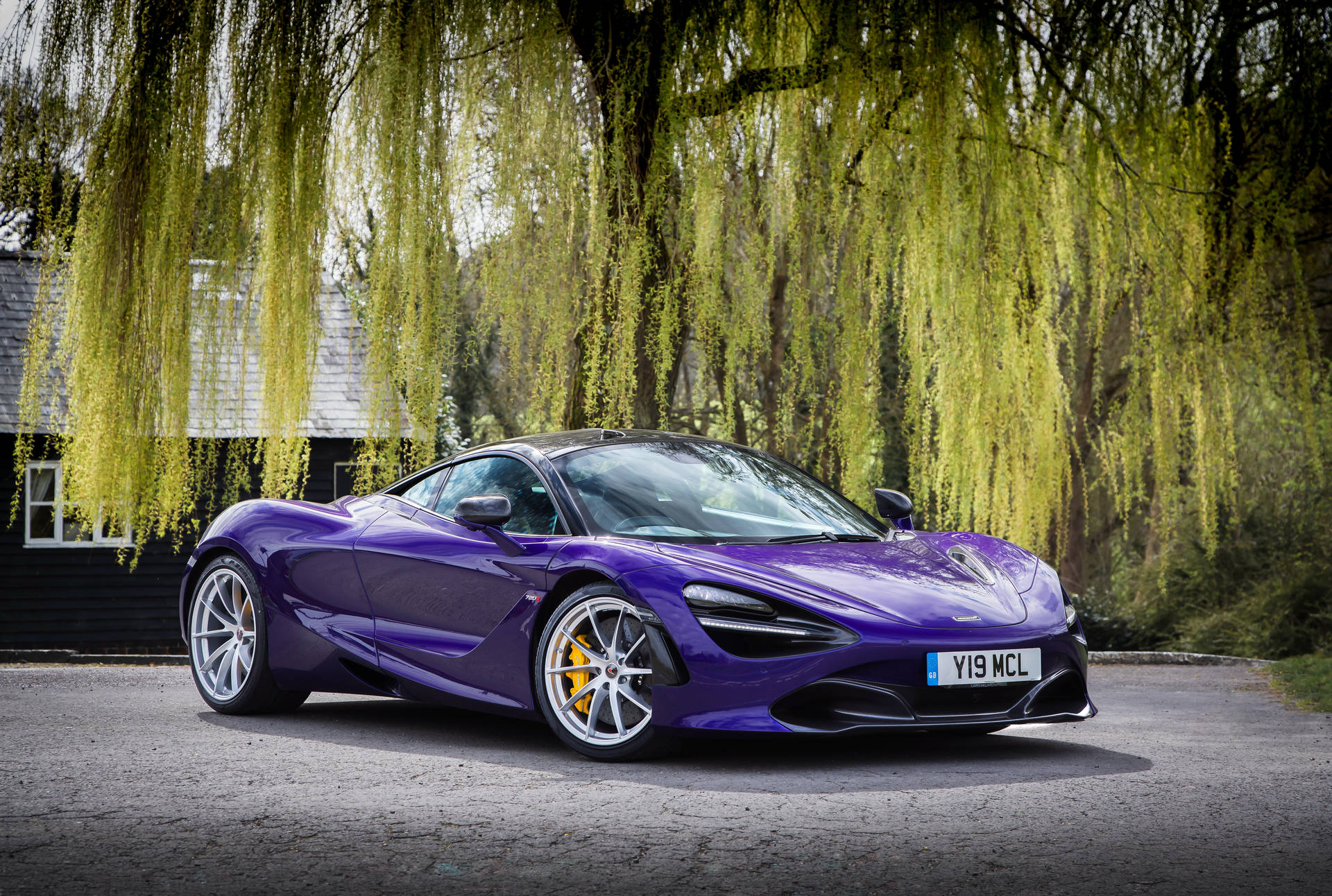 Showcasing Power and Luxury: The Stunning McLaren 720S in Violet Wallpaper