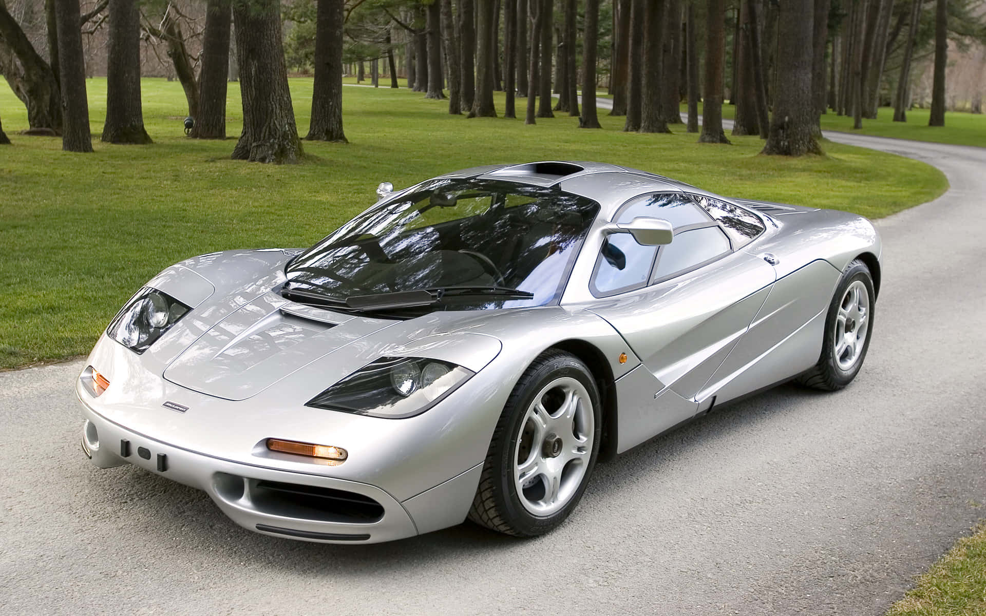 A stunning McLaren F1 sports car showcased against a breathtaking mountain backdrop. Wallpaper