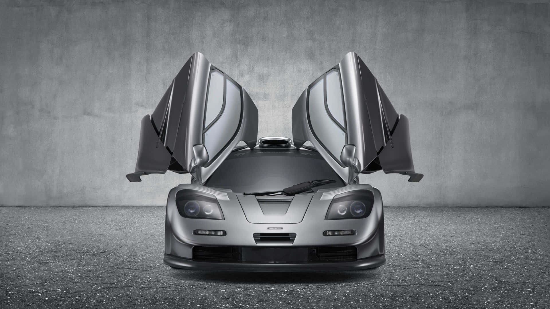 Sleek McLaren F1 Sports Car on Display in High Resolution Wallpaper