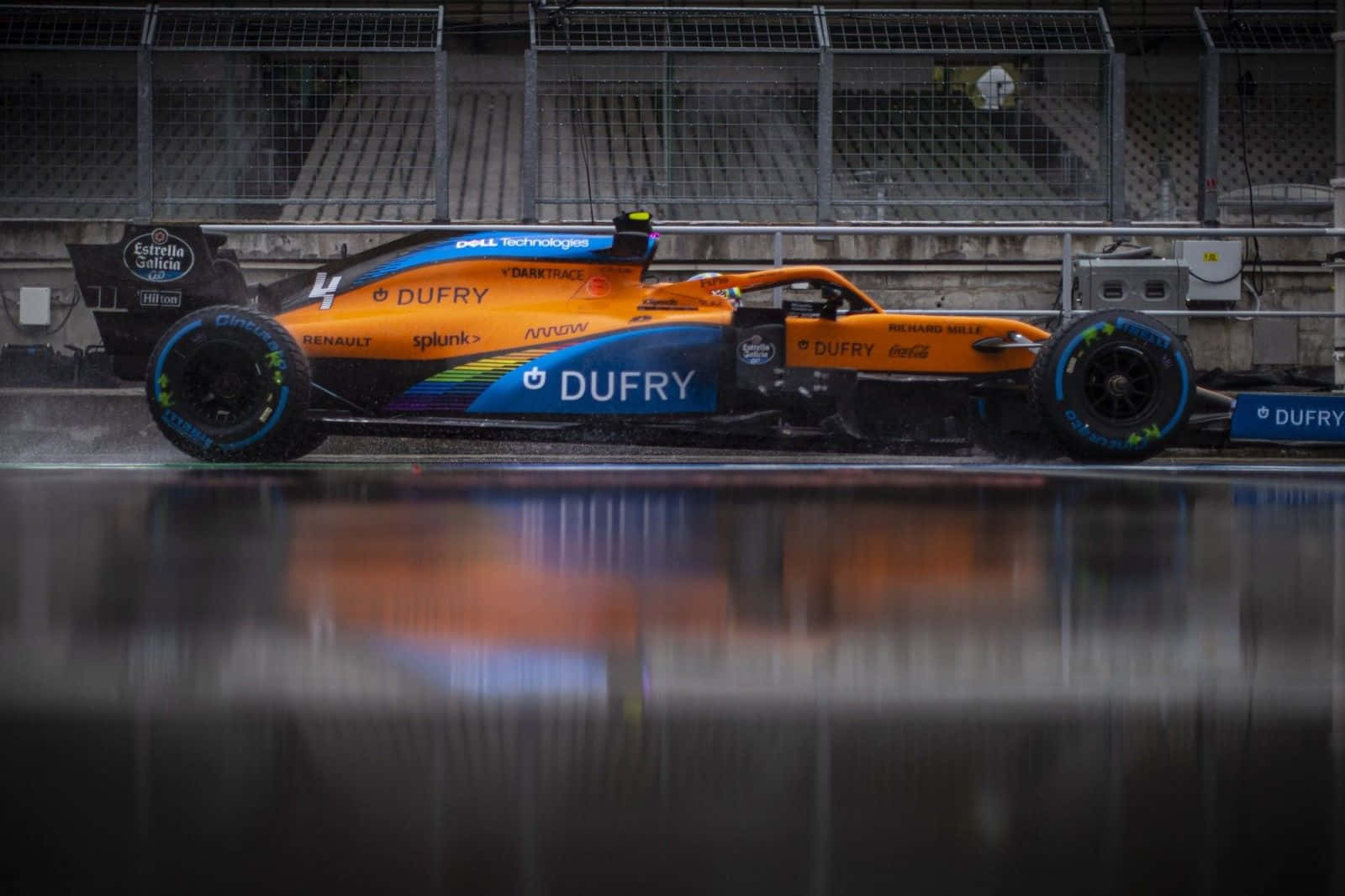 A Blue And Orange Racing Car Is Sitting On The Track Wallpaper
