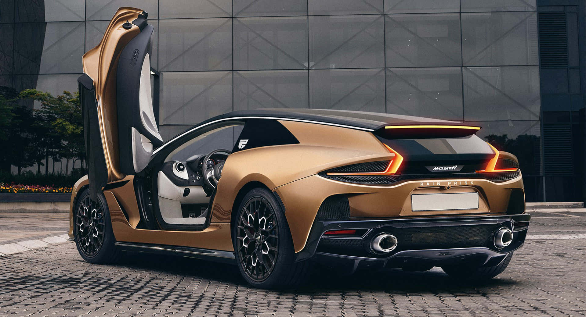 A McLaren GT roaring down an open road Wallpaper