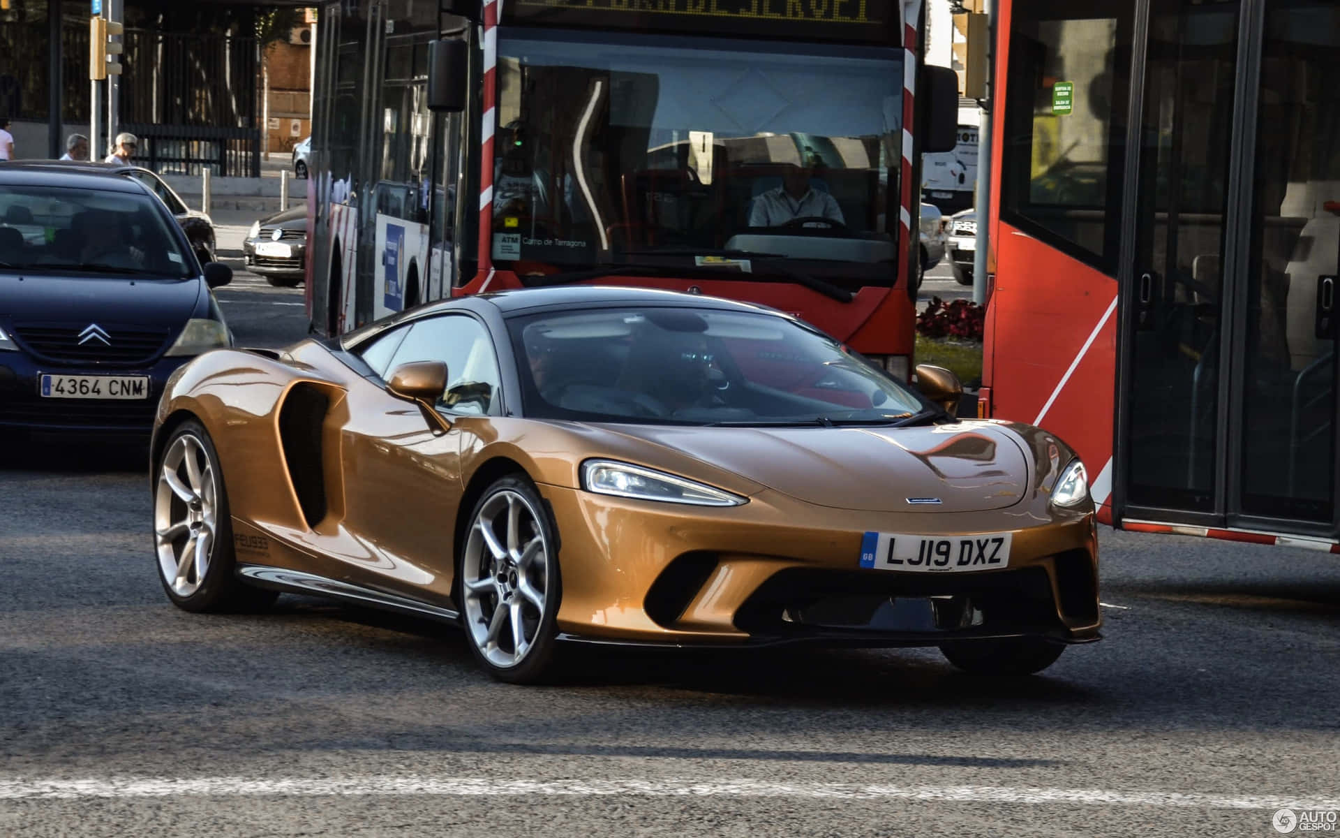 Stunning McLaren GT in motion on a scenic road Wallpaper