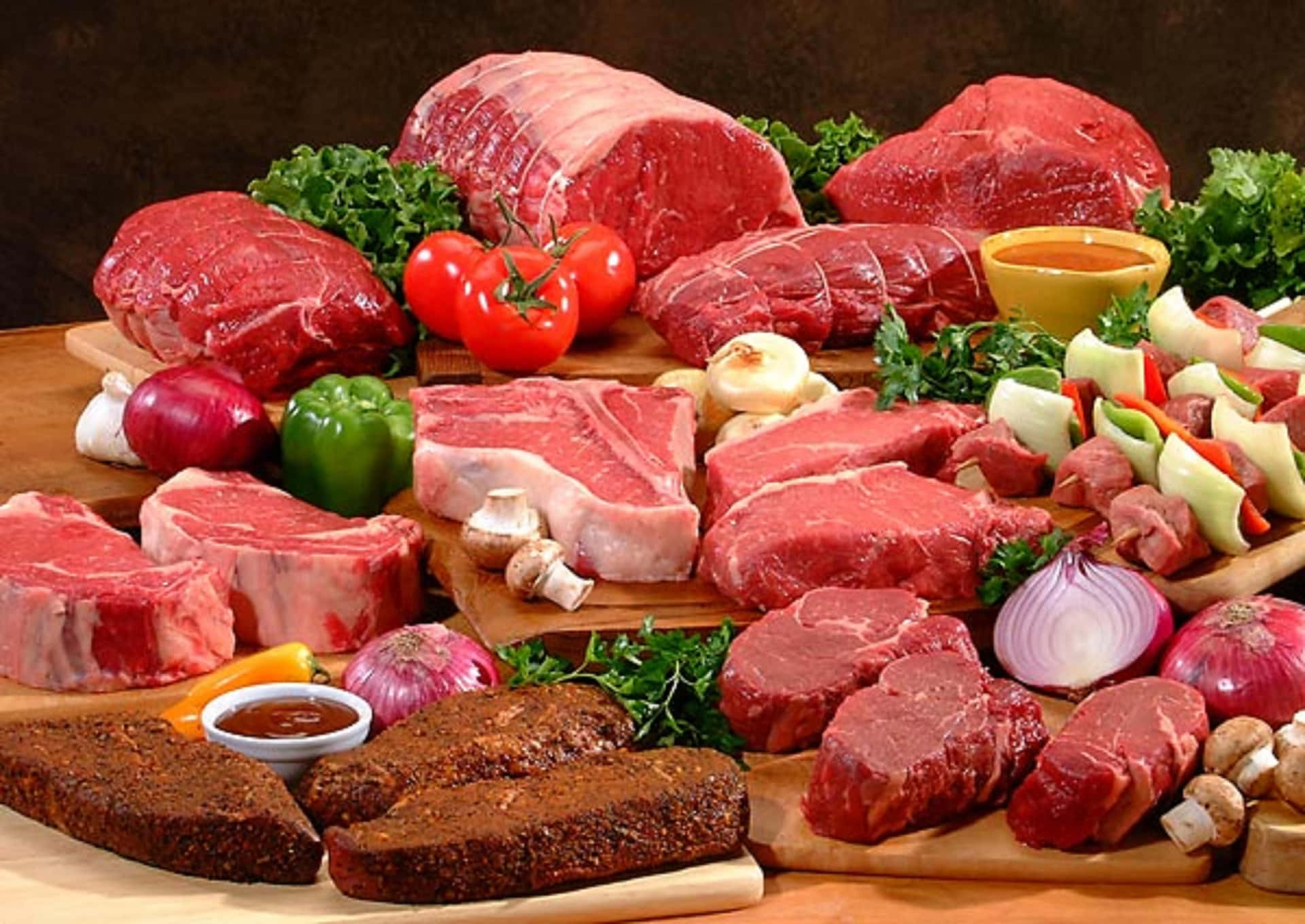 A Variety Of Meats And Vegetables On A Wooden Board