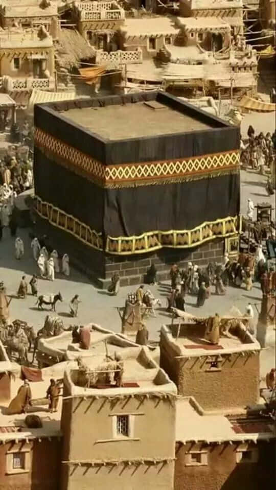 A Large Kaaba With People Around It
