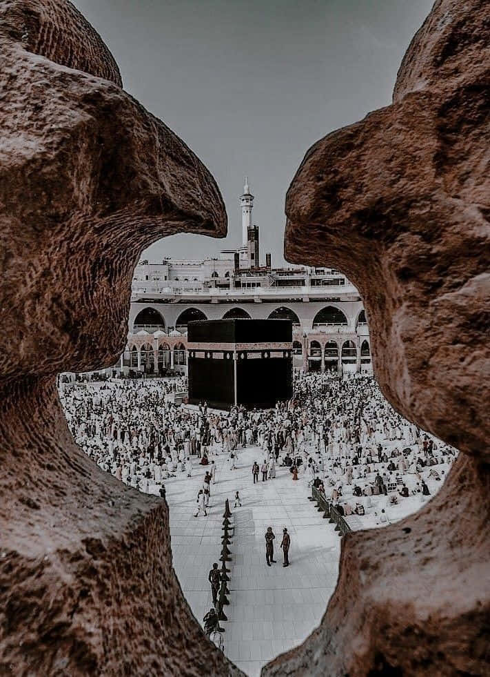 A Black And White Photo Of A Mosque With A Stone Wall