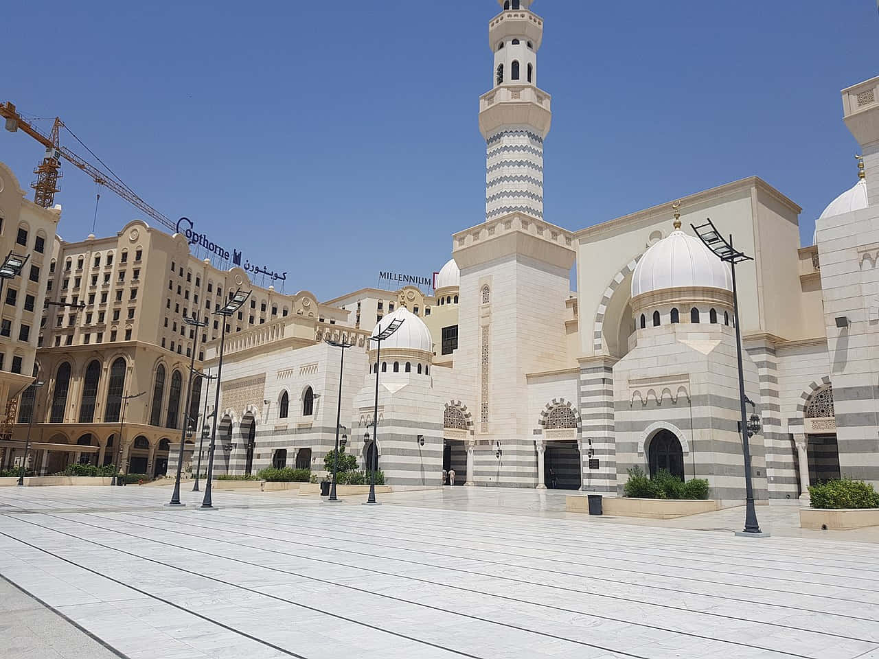 A Mosque With White Domes And White Buildings