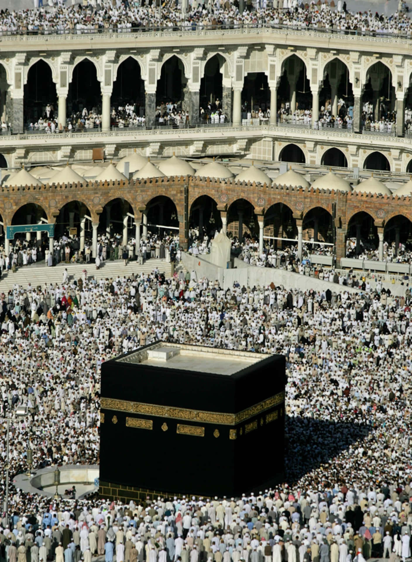 A Large Crowd Of People Are Gathered Around The Kaaba