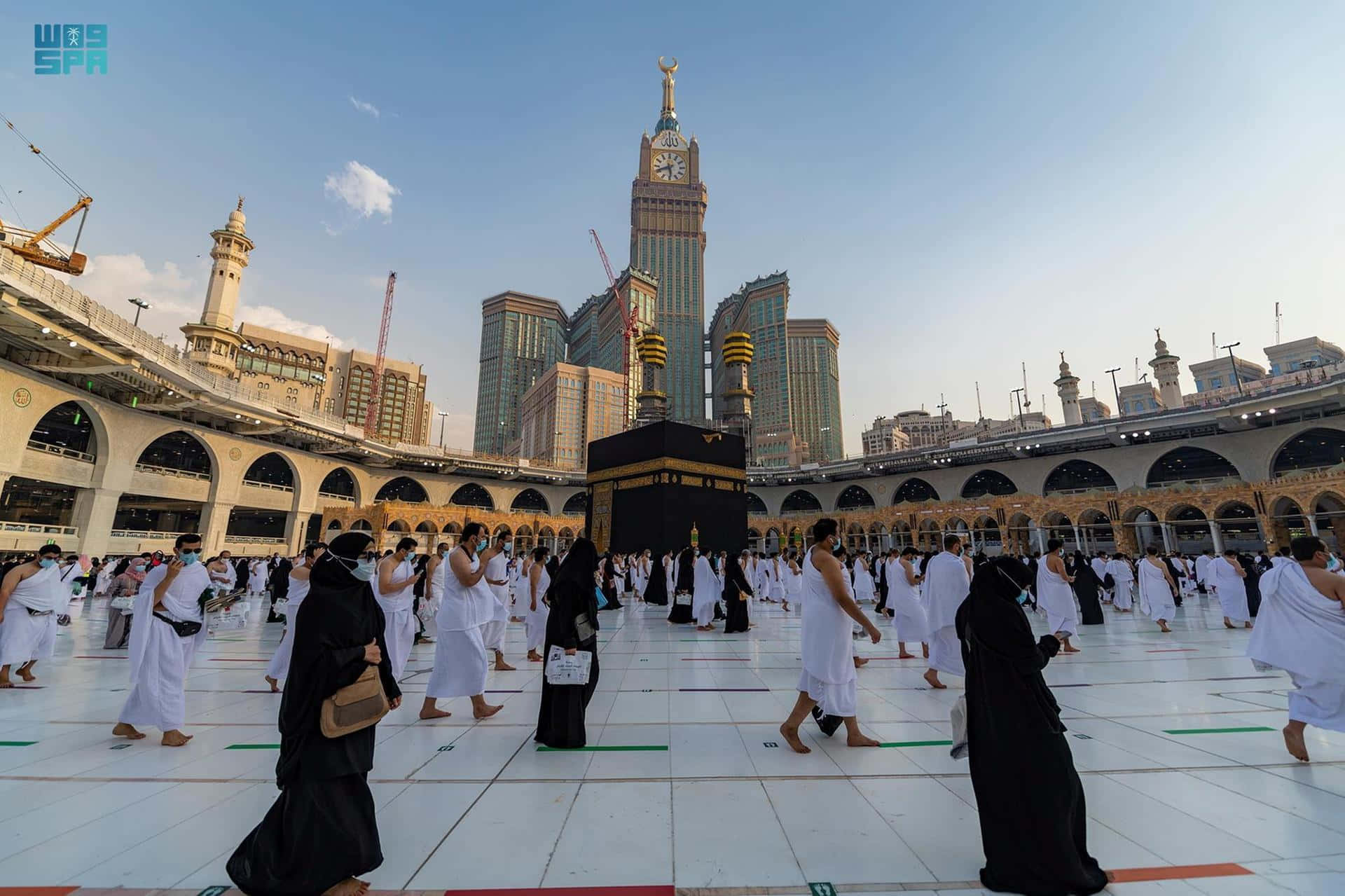 A Group Of People Are Standing In Front Of The Kaaba