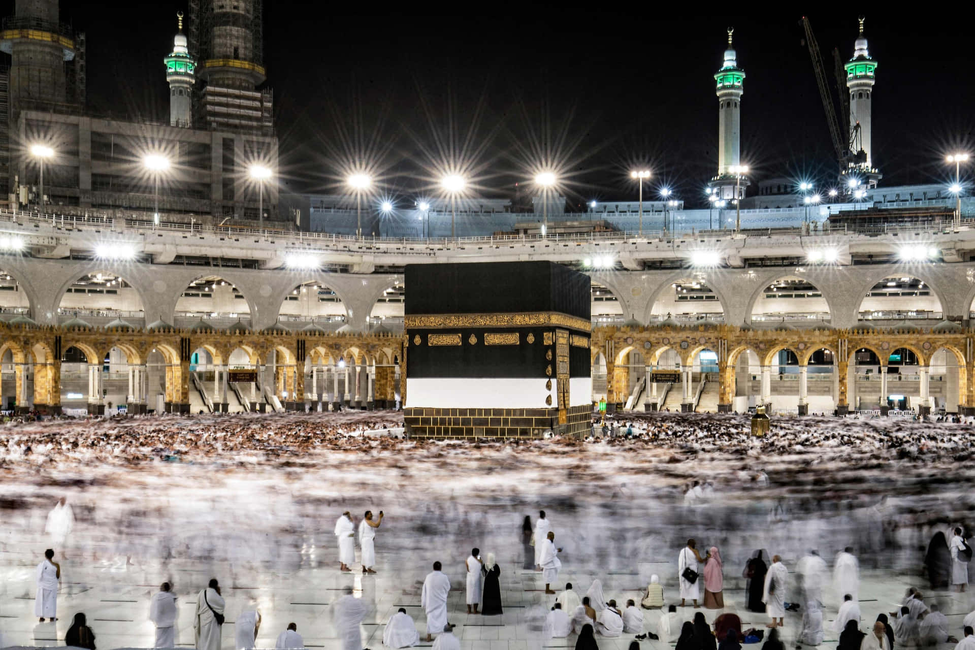 A Large Group Of People Are Standing Around The Kaaba