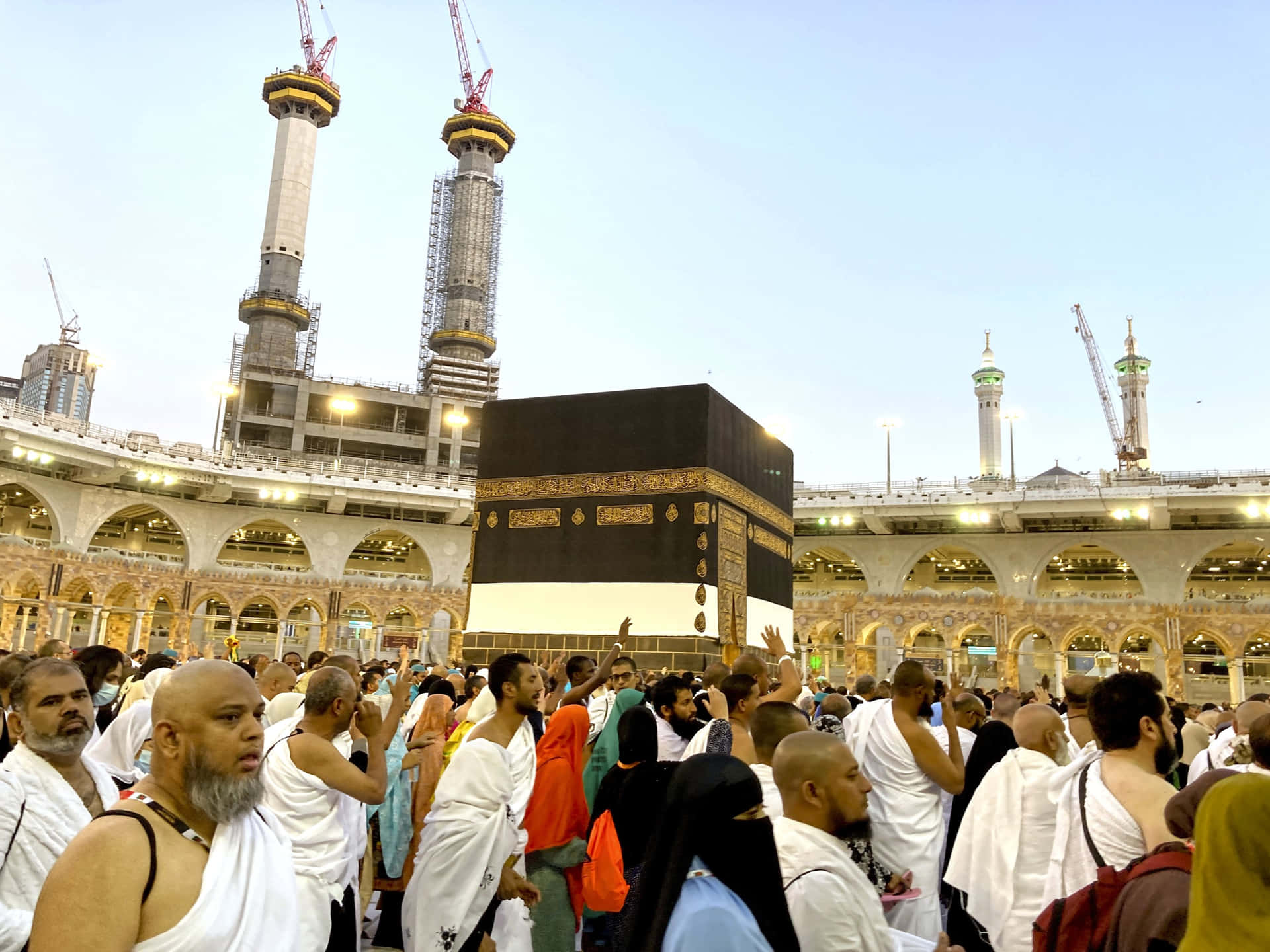 A Group Of People Are Standing Around A Kaaba
