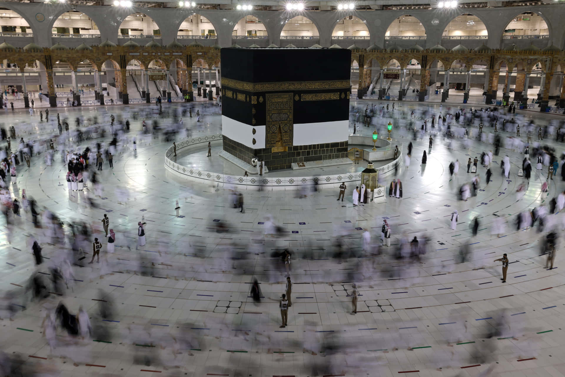 A Mosque With People Walking Around The Kaaba