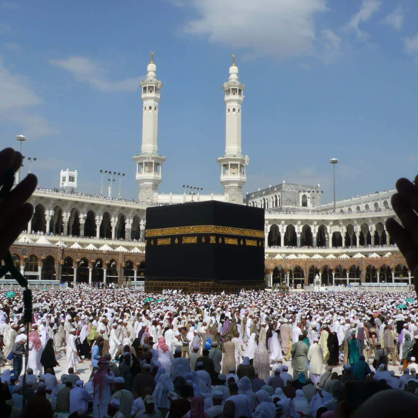 A Group Of People Are Standing Around The Kaaba