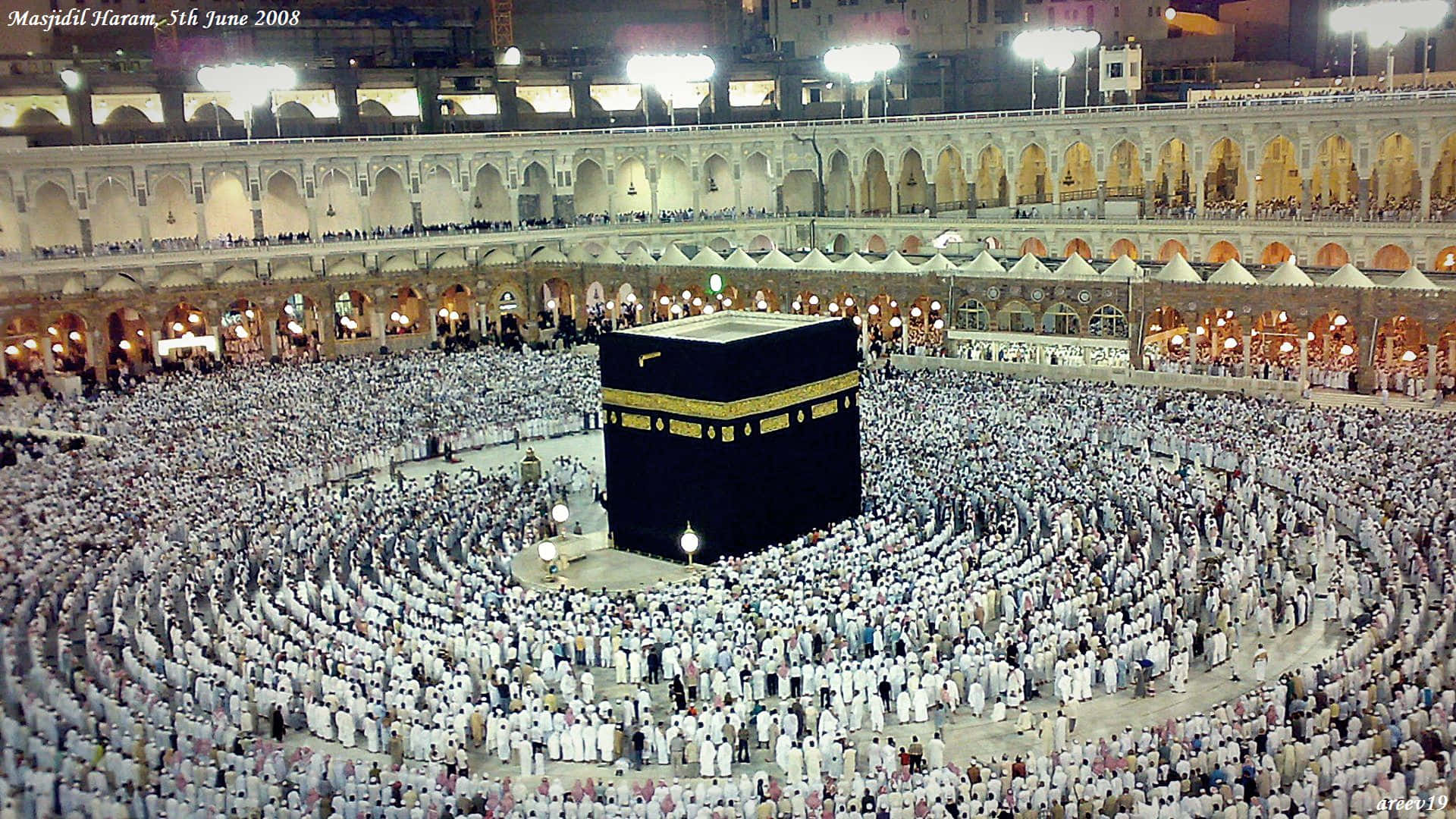 "The blue-tiled Kaaba surrounded by worshippers in the center of the Grand Mosque of Mecca in Saudi Arabia"