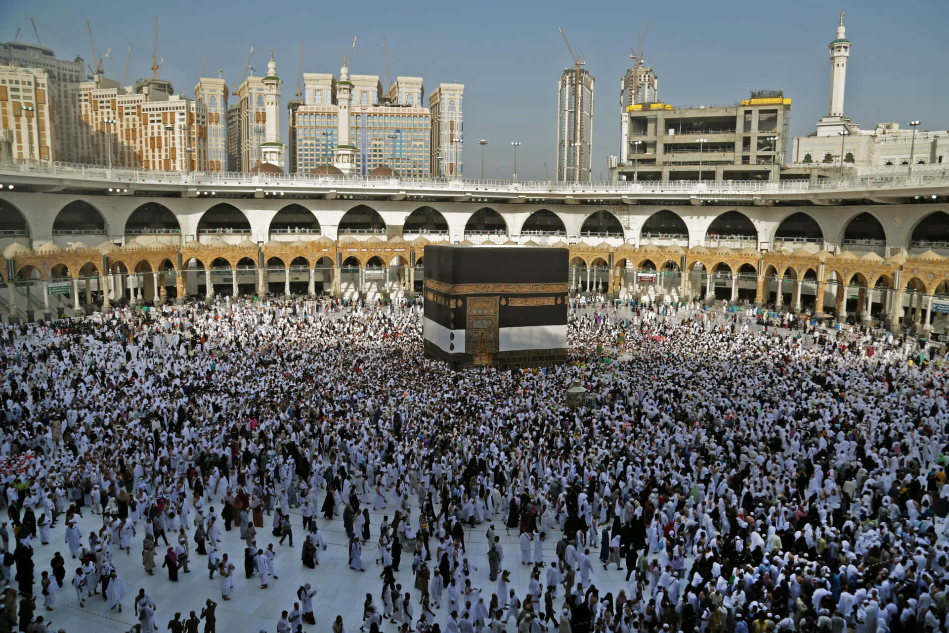 A Large Crowd Of People Gather Around The Kaaba