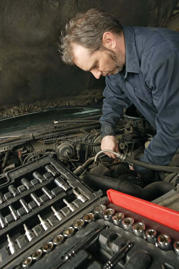 An experienced mechanic fixing an engine