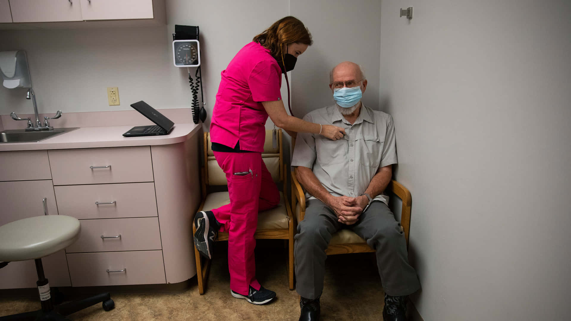 A Nurse Is Assisting A Patient In A Room