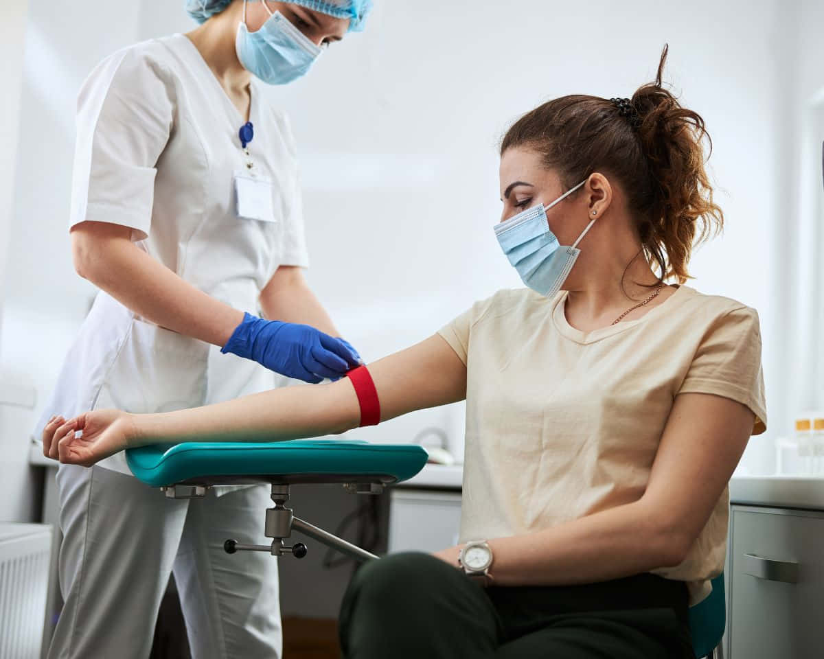 A Woman Is Getting A Blood Test In A Hospital