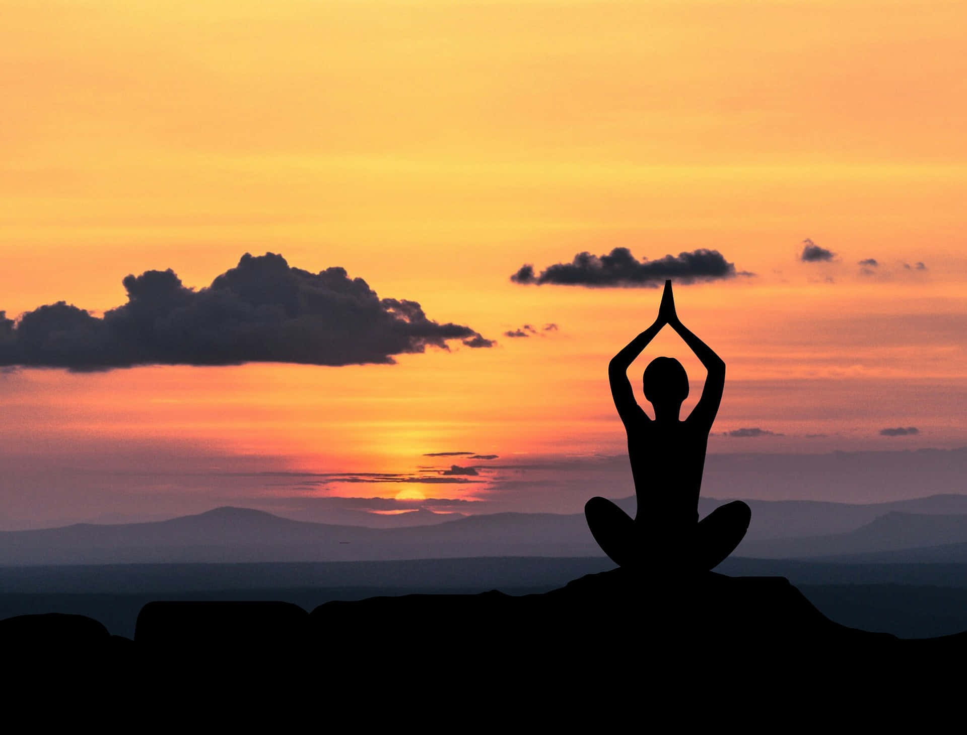 A Silhouette Of A Person Doing Yoga At Sunset