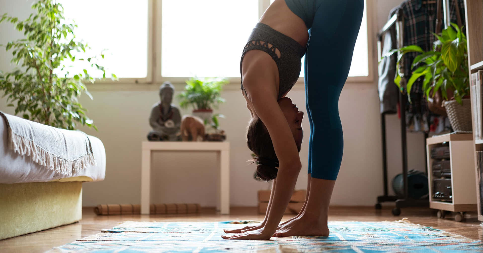 A Woman Doing Yoga In Her Bedroom Wallpaper