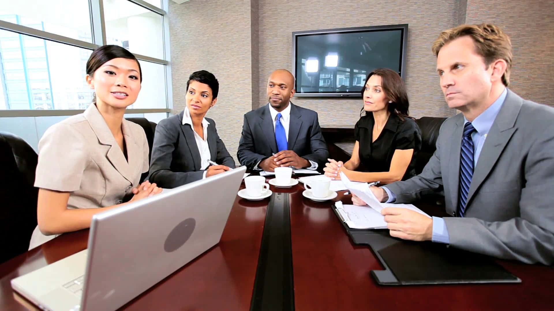 Business People Sitting Around A Conference Table