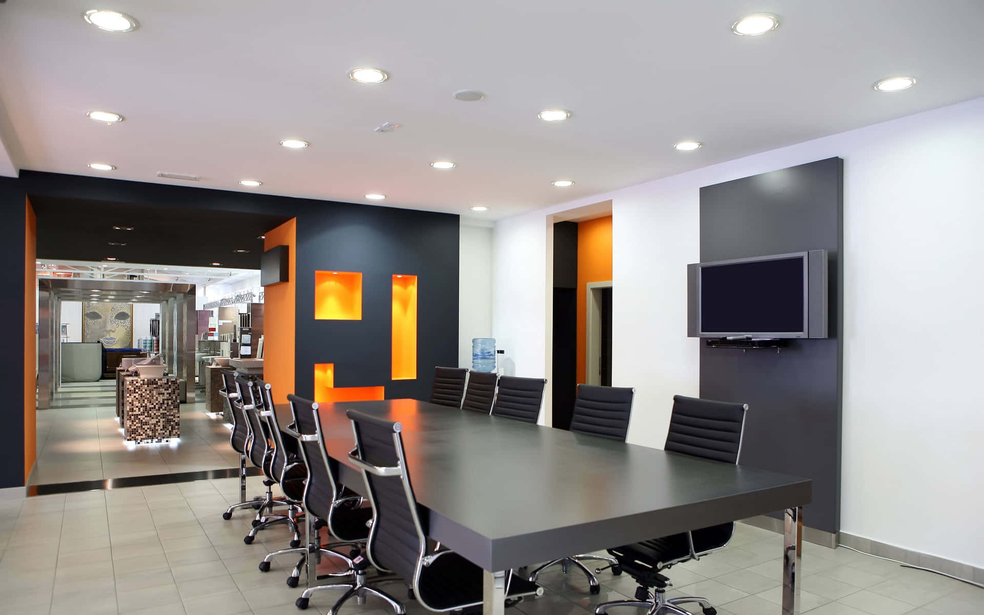 A Conference Room With Black Chairs And Orange Walls