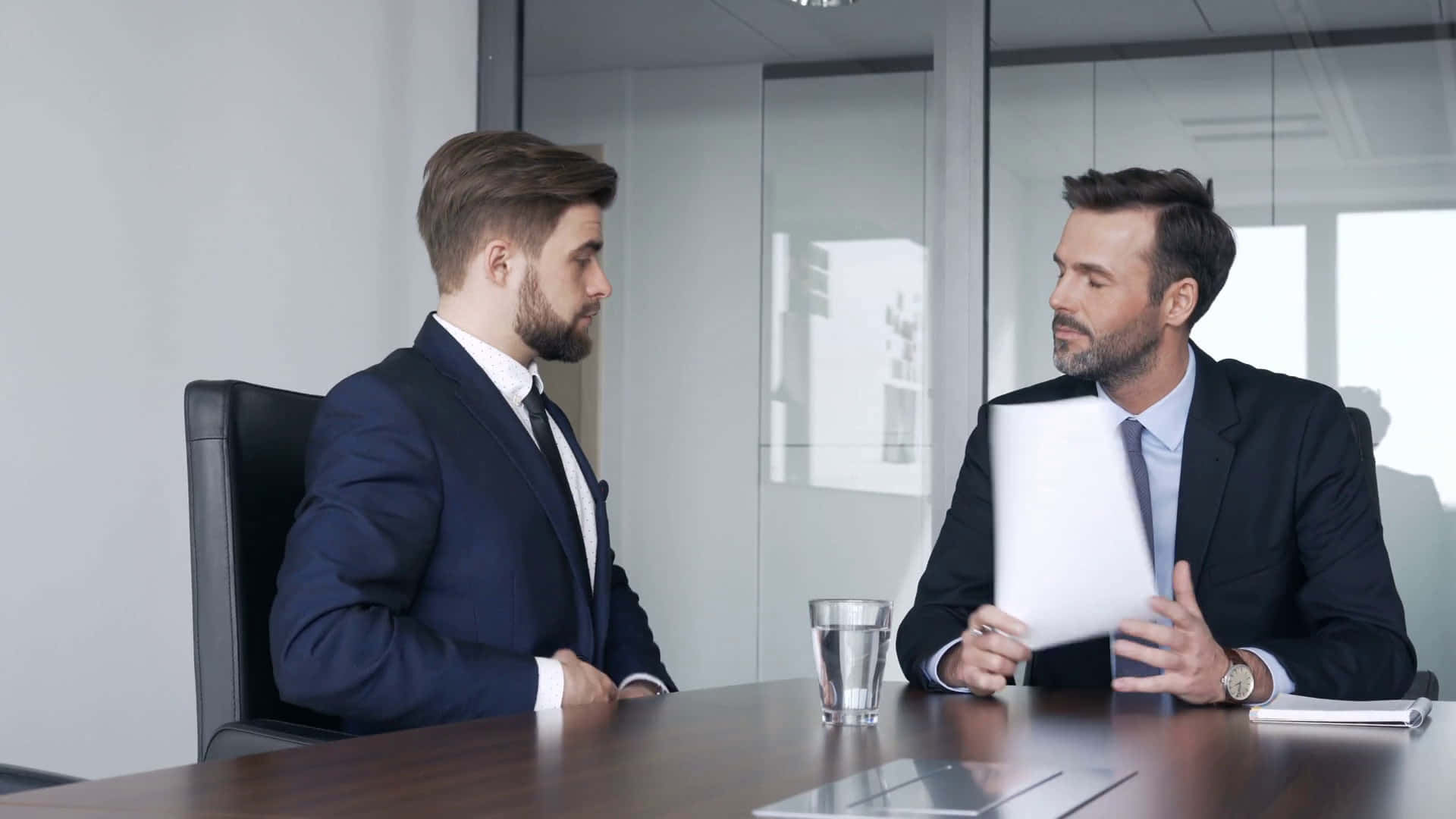 Two Businessmen Talking At A Meeting Table