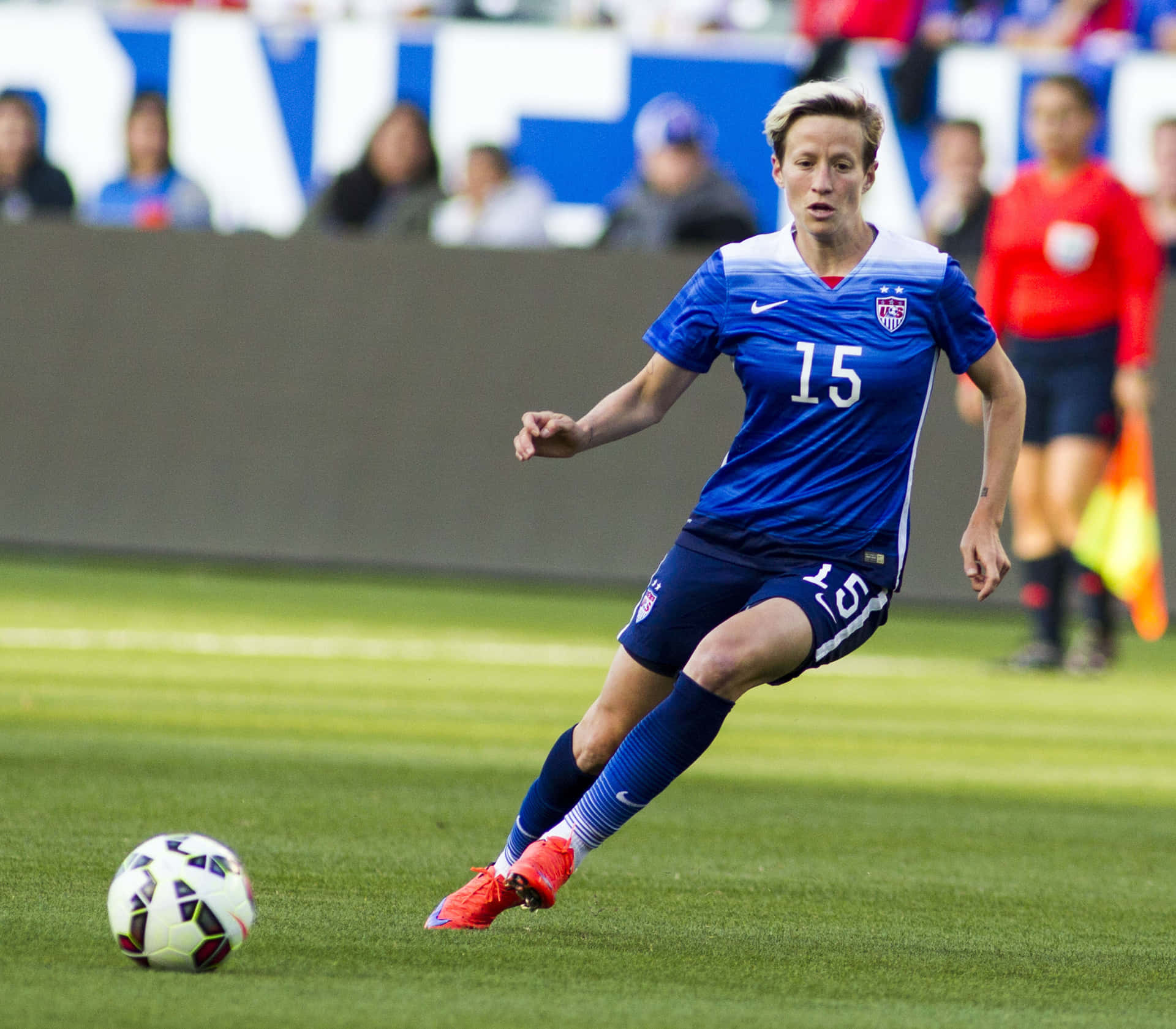 Megan Rapinoe In Action During A Soccer Match Wallpaper