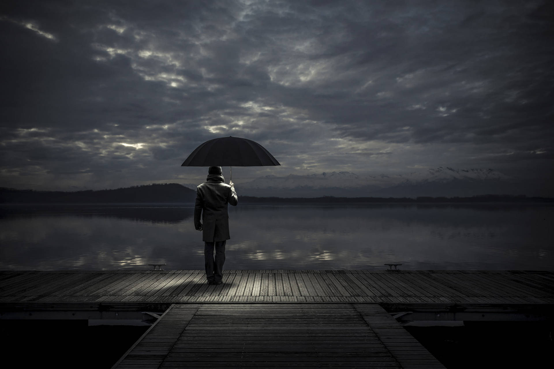 Melancholy Man Reflecting on Life at the Docks Wallpaper