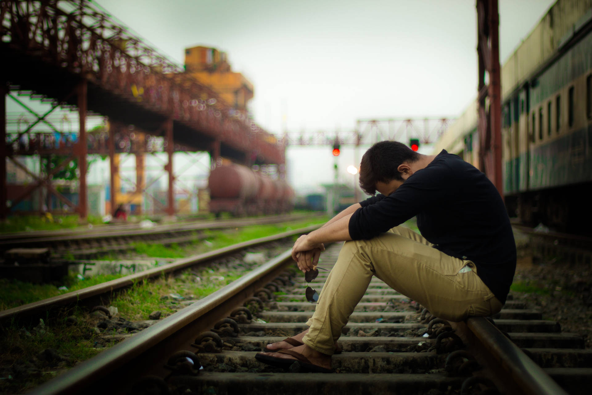 Melancholy Man On The Train Tracks Wallpaper