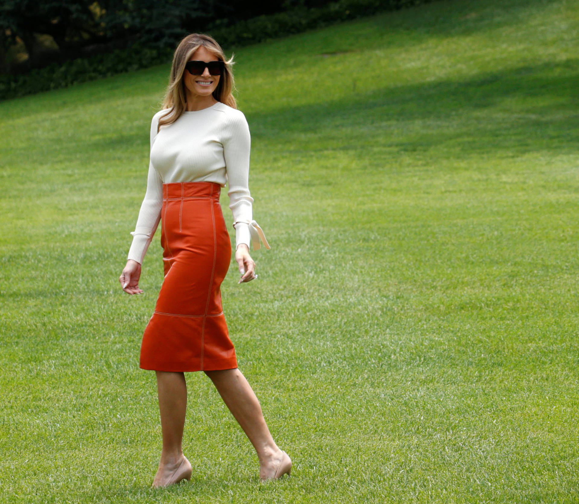 Melania Trump In Orange Skirt Wallpaper