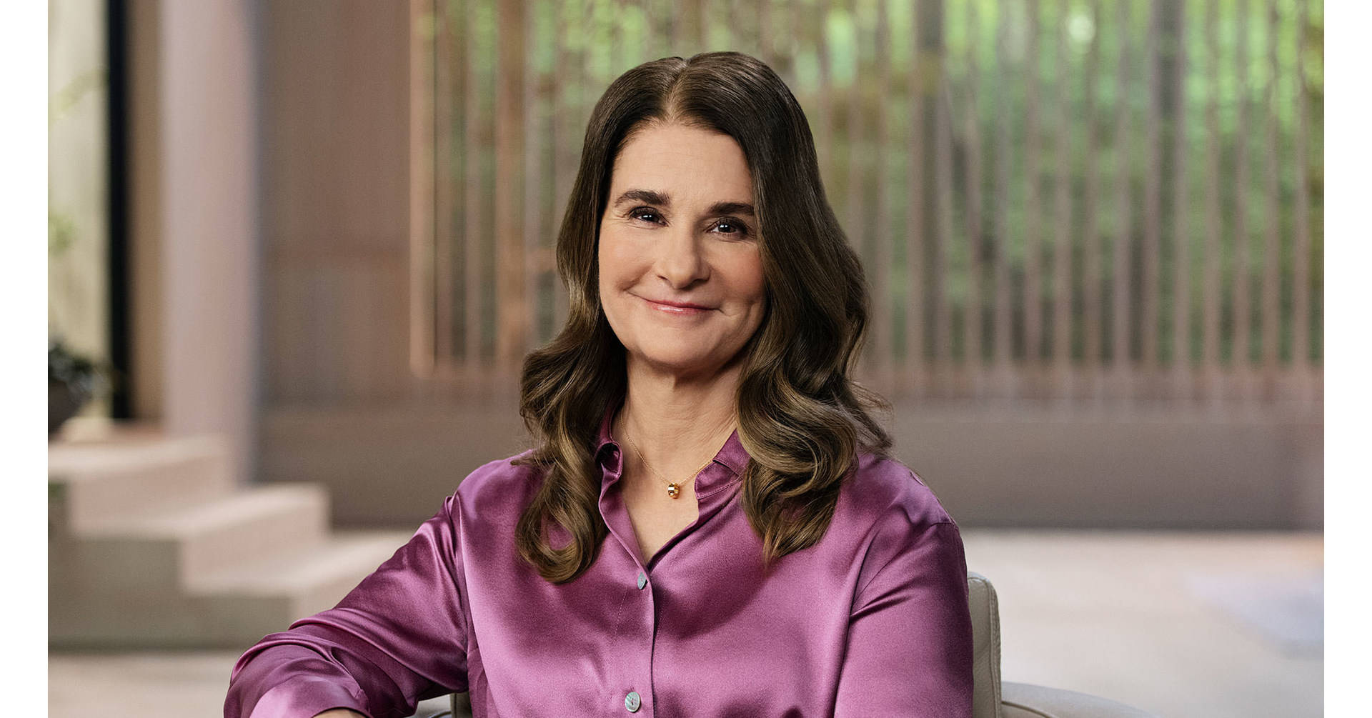 Melinda French Gates Donning A Purple Silk Top Background