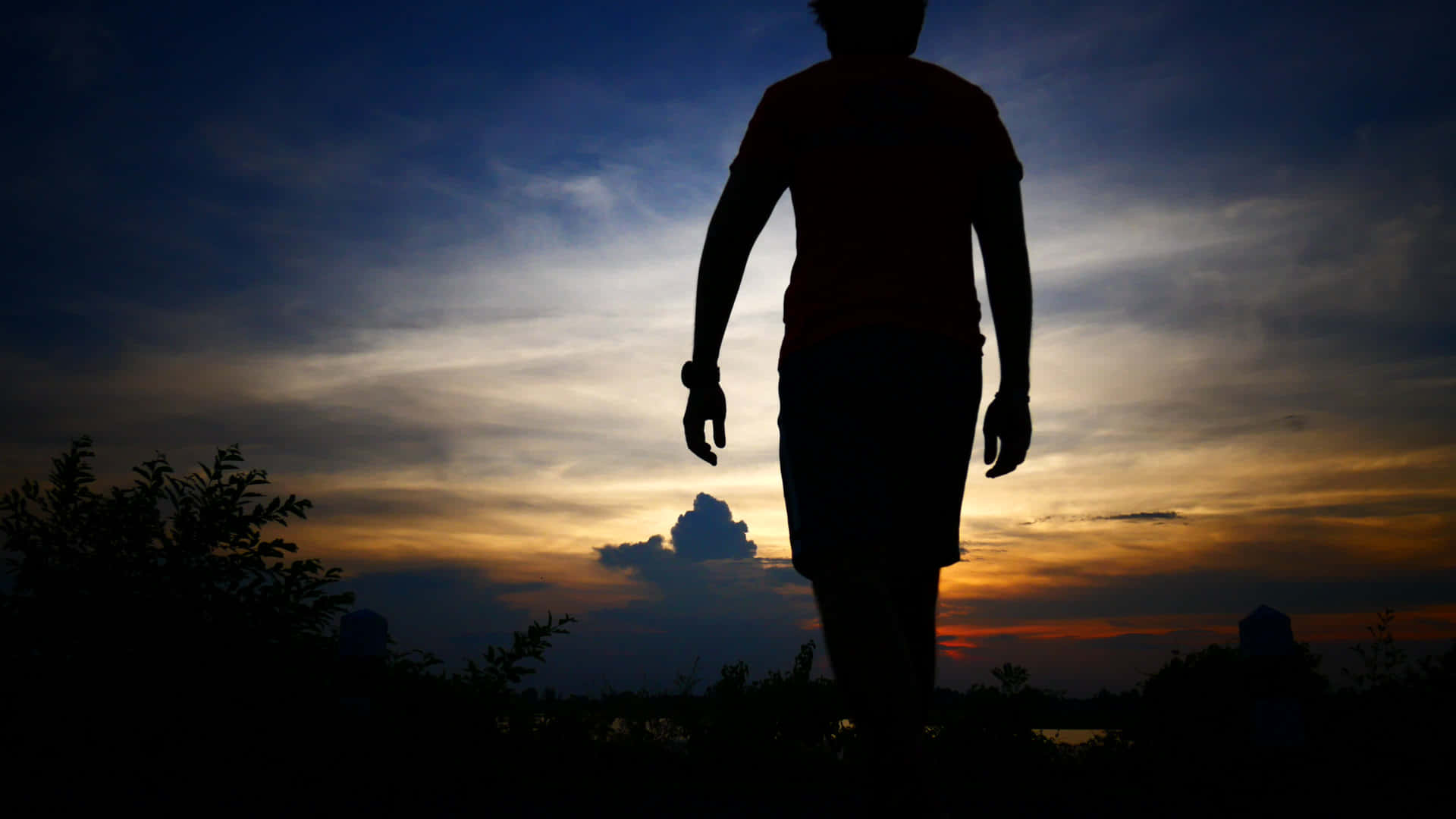 Silhouette Of A Man Walking In The Sunset