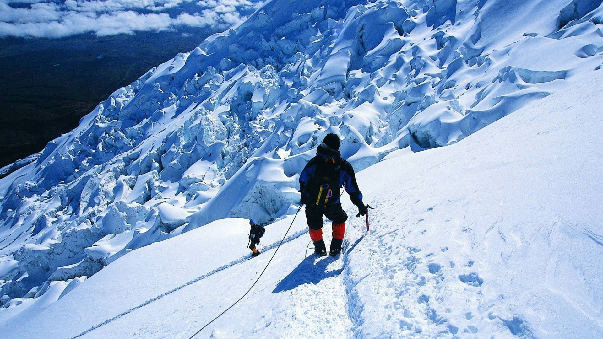 Men Climbing An Icy Rock Mountain Wallpaper